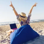 beautiful-young-woman-working-with-laptop-tropical-beach_273443-2279